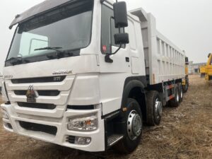 White SINOTRUK HOWO 8x4 dump truck front side view - HICA Vehicle