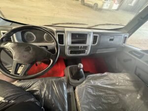 Interior view of SINOTRUK HOWO 4x2 light cargo truck cabin showing steering wheel, dashboard, and gear shift - HICA Vehicle