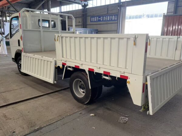 Rear view of a white SINOTRUK HOWO 4x2 light cargo truck with its side-drop cargo box gates open, showcasing the payload area - HICA Vehicle