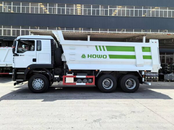 Direct rear view of green SINOTRUK HOWO TX 6x4 dump truck cargo box and rear axle