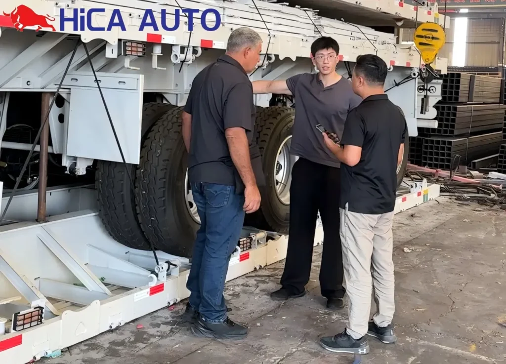 Oman logistics client inspecting 3-axle flatbed semi-trailers at HICA AUTO factory workshop