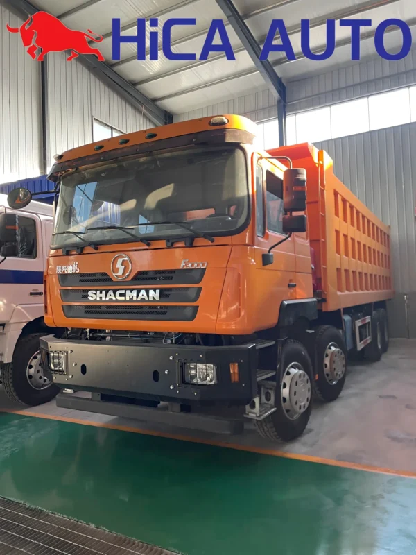 Right front side view of orange SHACMAN F3000 8x4 dump truck with reinforced tipper box