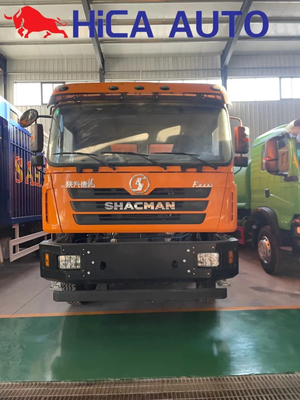 Front view of orange SHACMAN F3000 8x4 dump truck with steel mining bumper