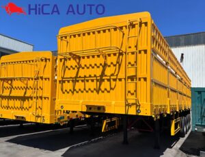 Yellow 3-axle stake semi-trailer with detachable fence and front bulkhead ladder by HICA AUTO