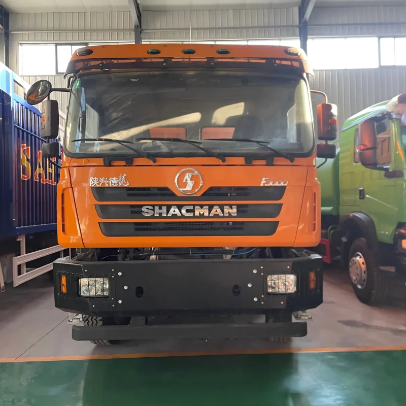 Front view of orange SHACMAN F3000 8x4 dump truck with steel mining bumper